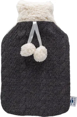 A close-up studio shot of a hot water bottle with a knitted cover.