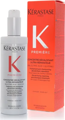 A bottle of Kerastase Premiere hair treatment next to its orange packaging box.