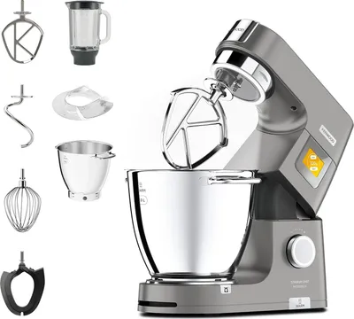 A kitchen mixer with various attachments displayed around it.