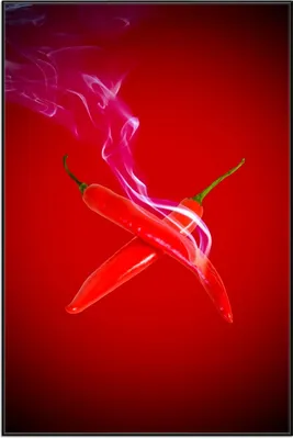 Produktbild von Wallario Wandbild Rauchende Chili-Schoten im Duo vor rotem Hintergrund, Größe: 61 x 91,50 cm, Poster mit schwarzem Aluminiumrahmen