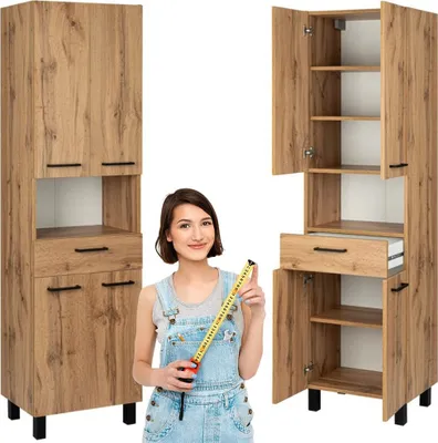 A woman is holding a measuring tape in front of two tall cabinets.