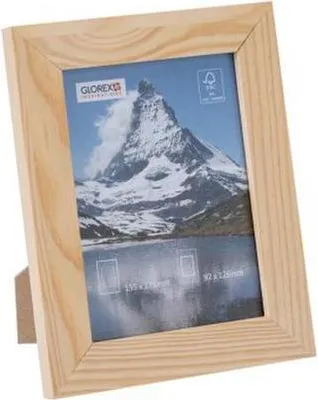 A wooden picture frame with a landscape photo inside.