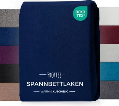 A folded navy blue fitted sheet is shown, with a swatch of other colors in the background.