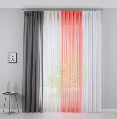 A room interior with curtains hanging in front of a window.