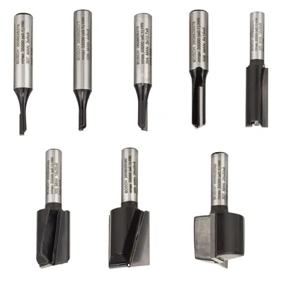 A collection of router bits arranged in two rows against a white background.
