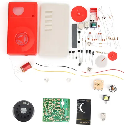 A collection of electronic components and parts for a radio kit, laid out on a white background.