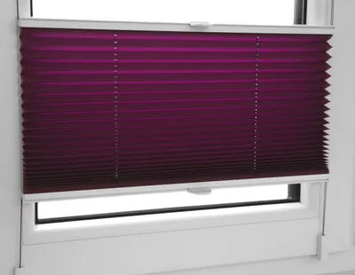 A close-up view of a purple pleated blind installed on a white window frame.