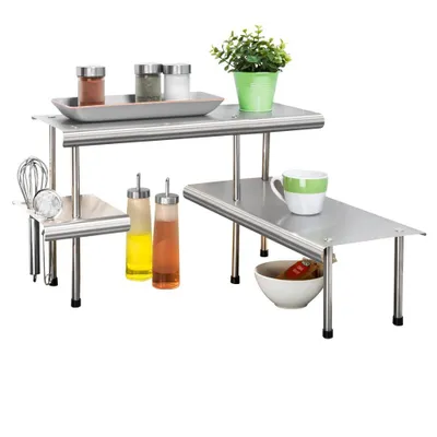 A multi-tiered stainless steel shelving unit with various kitchen items on it.