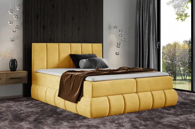 A yellow upholstered bed with pillows and a throw blanket is shown in a bedroom setting with a large window and curtains.