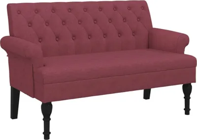 A studio shot of a red loveseat with black legs.