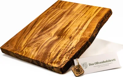 A rectangular olive wood cutting board with a live edge, shown on a white background with a small tag attached.