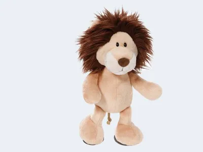 A plush toy lion standing against a white background.