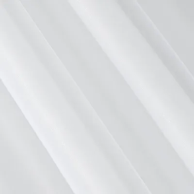 A close-up view of white pleated fabric, likely a curtain or textile.