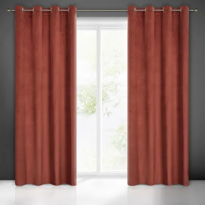 Two red curtains are hung on a curtain rod in front of a window.