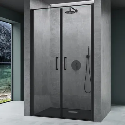 A modern shower enclosure with black frames and glass doors, set against a concrete-like wall.