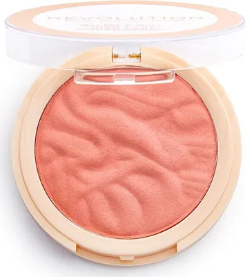 A makeup revolution blusher reloaded ballerina powder rouge in a light peach color with a wavy texture, shown in its open compact packaging against a white background.