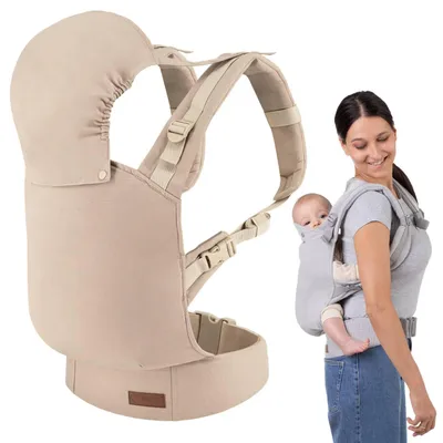 A woman is wearing a baby carrier with a baby in it, and a separate baby carrier is shown on the left.