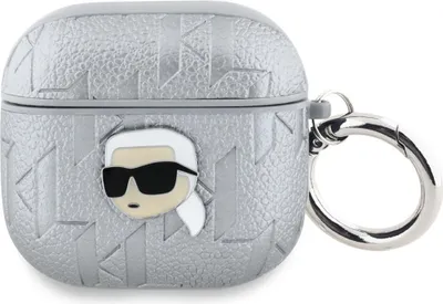 A close-up, front-facing view of a silver AirPods case with a Karl Lagerfeld head graphic and a silver keyring attached.