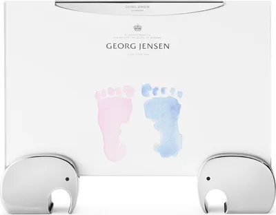 A Georg Jensen picture frame with elephant-shaped stands, featuring watercolor footprints.