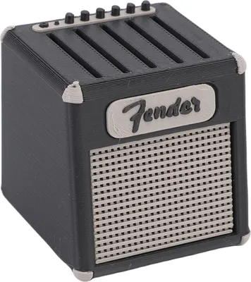 A miniature replica of a Fender guitar amplifier, used as a pick holder.