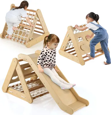 Three children are playing on wooden climbing structures with slides and nets.