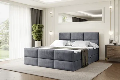 A bedroom scene with a large bed as the focal point.