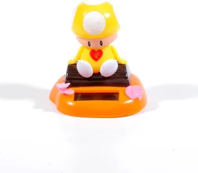 A solar-powered dancing toy figure of a yellow mushroom character sitting on a brown bench.