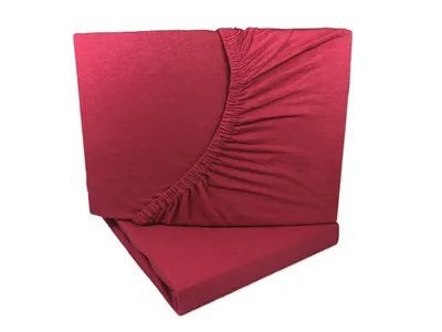 Two folded fitted sheets are stacked on top of each other against a white background.