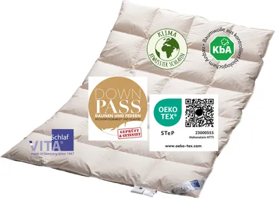 A cream-colored down comforter is laid out flat, showing its quilted pattern. Several certification logos and text labels are overlaid on the comforter.