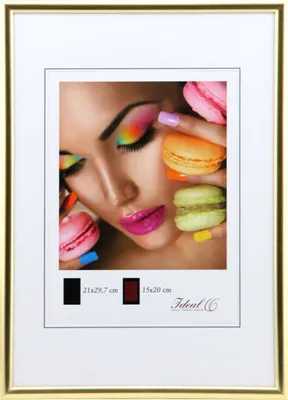 A framed picture of a woman with colorful makeup and macarons.