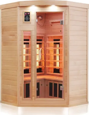 An infrared sauna cabin with glass doors and wooden interior, illuminated by orange heating elements.