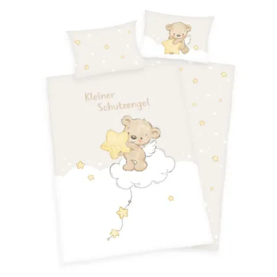 A flat lay of a baby bedding set featuring a teddy bear angel motif.
