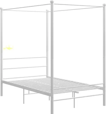 A white metal four-poster bed frame.