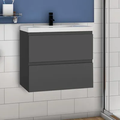 A modern bathroom vanity with a dark gray cabinet and a white sink, mounted on a tiled wall.