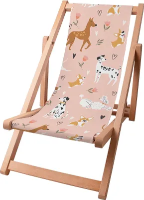 A pink deck chair with a cartoon dog pattern.
