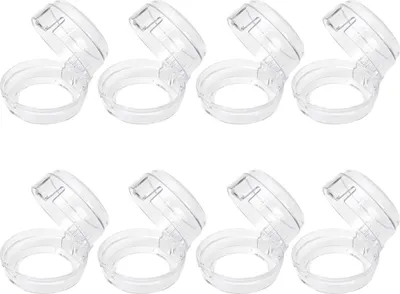 A set of eight clear plastic stove knob covers arranged in two rows of four.