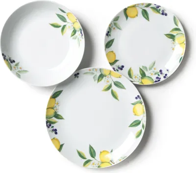 Three white plates with a lemon and leaf pattern are arranged on a white background.