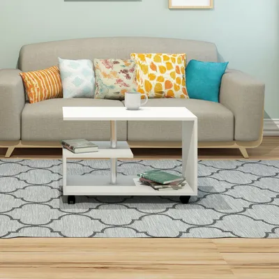 A living room scene with a couch, coffee table, and rug.