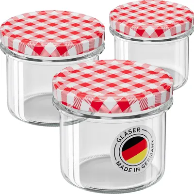 Three glass jars with red and white checkered lids are arranged in a group.