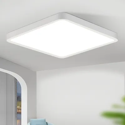 A white square LED ceiling light mounted on a white ceiling.