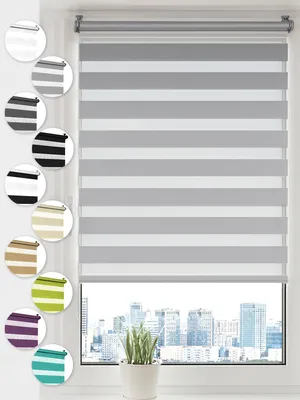 A window with a grey and white striped roller blind, with a city skyline visible through the window.