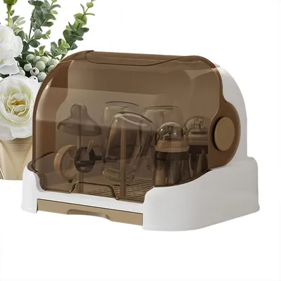 A baby bottle drying rack with brown and white parts, set against a white background with some floral decoration on the left.