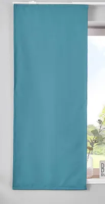 A teal panel curtain hanging in front of a window.