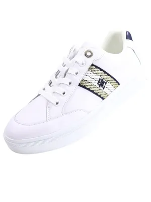 A single white sneaker with gold and navy accents is shown against a white background.