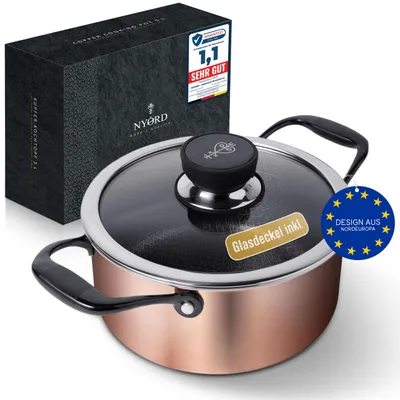A copper pot with a glass lid and black handles, placed next to its packaging box. There are several promotional stickers on the pot and the box.