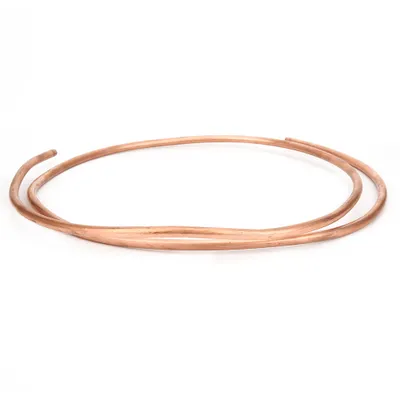Two copper tubes are coiled on a white background.