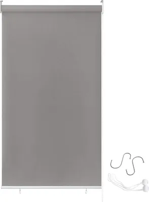 A gray roller blind is shown against a white background, with some accessories on the right side.