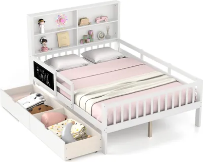 A white children's bed with a headboard bookshelf and two drawers underneath, shown with pink bedding and some decorative items on the shelves.