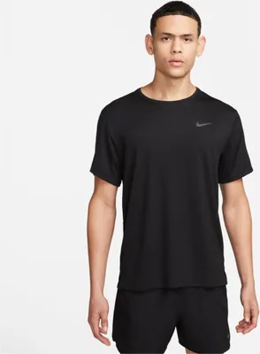 A man wearing a black Nike t-shirt and black shorts against a white background.