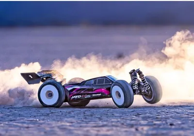 A remote-controlled car kicking up dust on a dirt track.